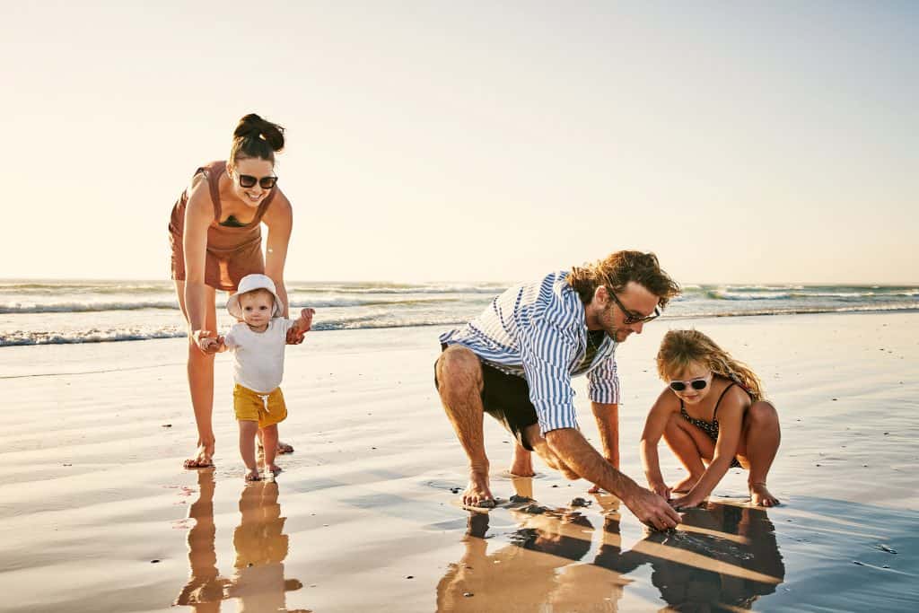 Family playing on the sand