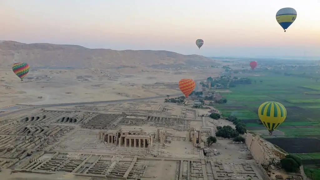 Hot air balloons rise over Luxor